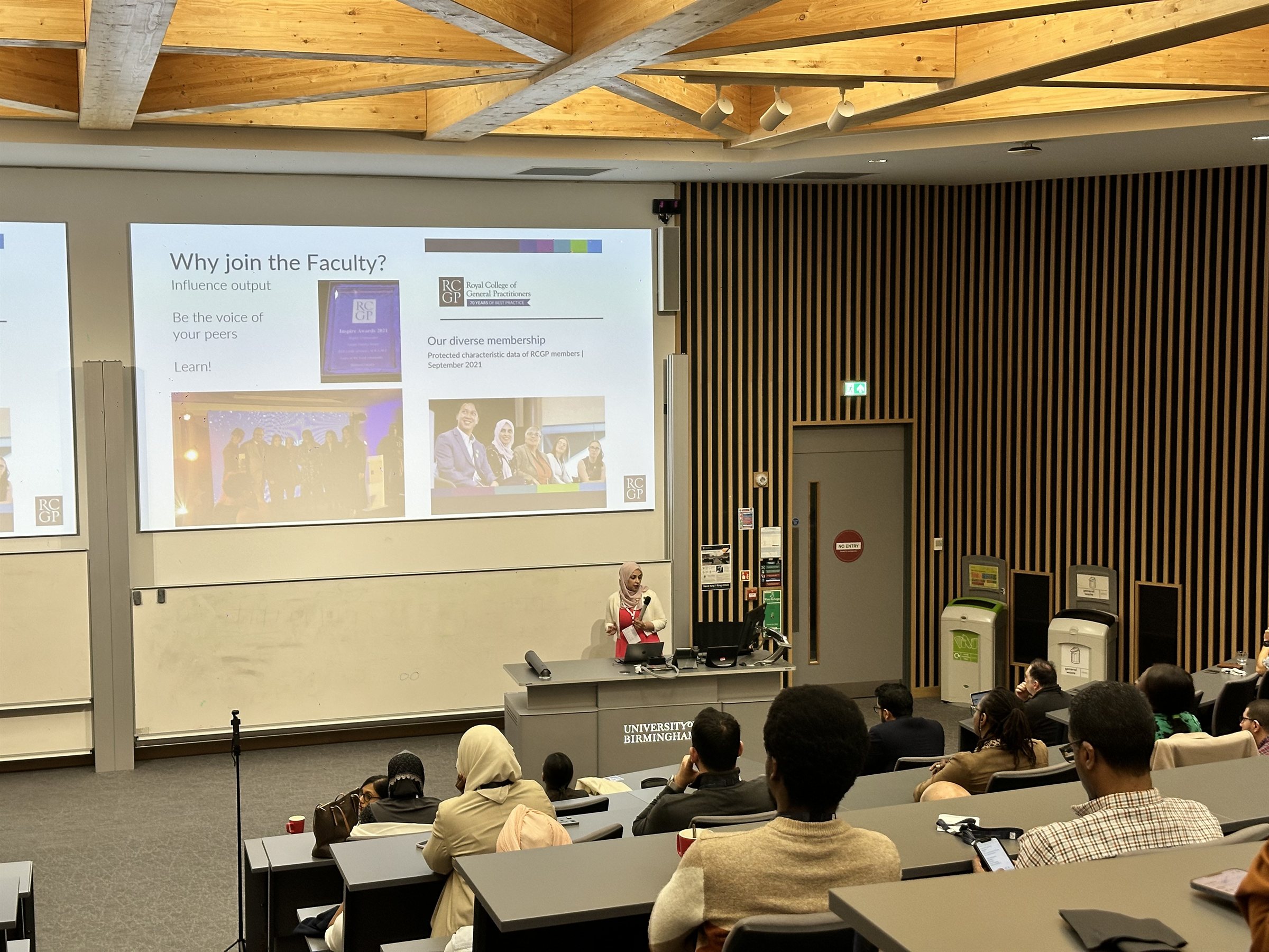 Dr Aaliya Goyal speaking in a lecture theatre at the University of Birmingham